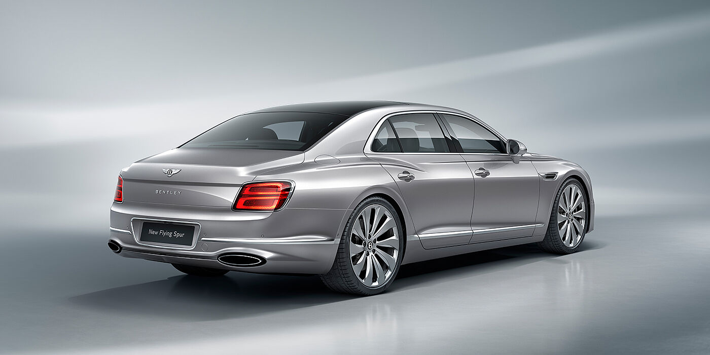Bentley Madrid New Bentley Flying Spur sedan rear view in Silverlake paint with ten spoke wheels and chrome matrix grille