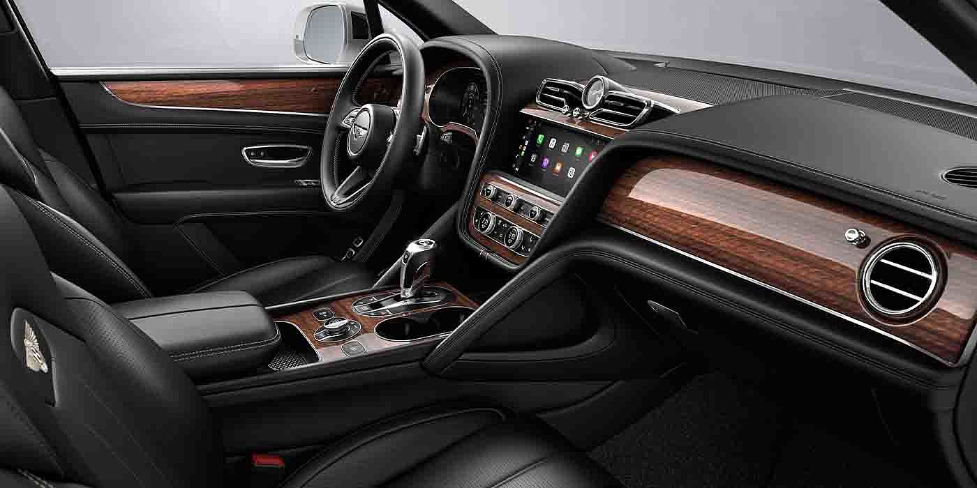 Bentley Madrid Bentley Bentayga EWB interior with a Crown Cut Walnut veneer, view from the passenger seat over looking the driver's seat.