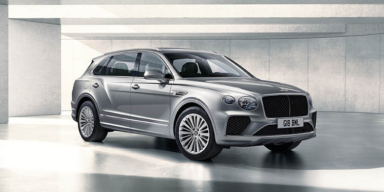 Bentley Madrid Bentley Bentayga Extended Wheelbase SUV front three quarter in Moonbeam paint with a grey background